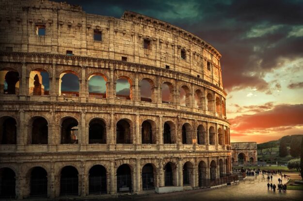 One of the most popular travel place in world – Roman Coliseum under evening sun light and sunrise sky.