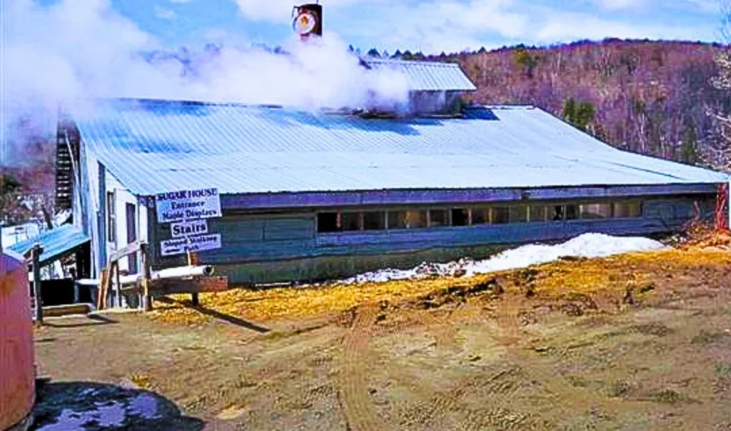 an old building with smoke coming out of the chimney