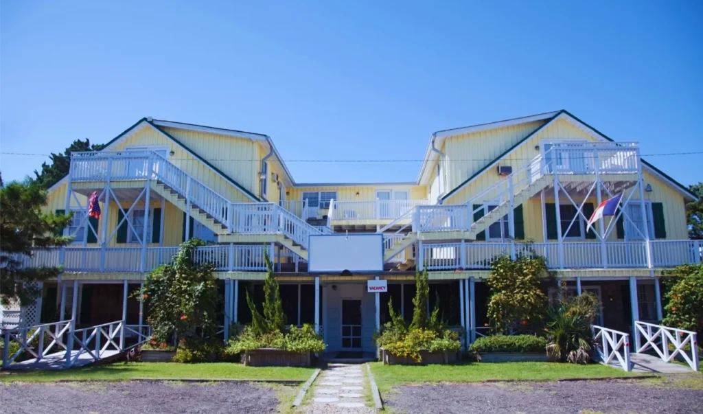 a yellow building with white balconies and balconies